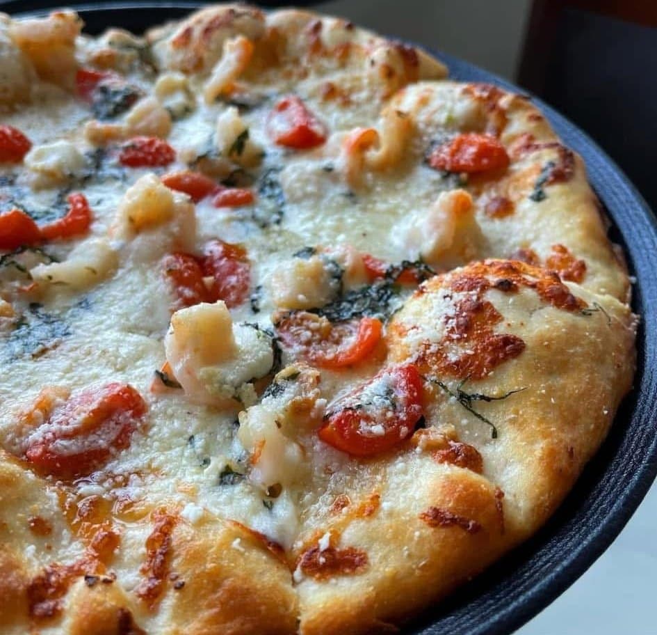 A La Bocca pizza topped with shrimp, tomato and melted mozzarella